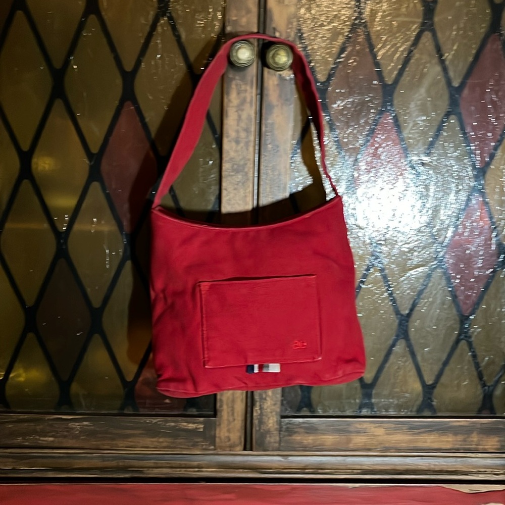 Vintage Y2K American Eagle red purse with multicolored striped ribbon accents.